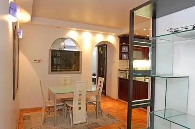 a dining room and kitchen with a table and chairs at Belgrade Republic Square Apartment in Belgrade