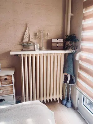 a bedroom with a radiator and a shelf with a toy boat on it at Vanja in Čukarica