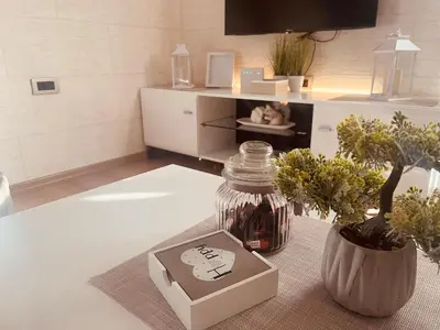 a living room with a table with a jar and a vase at Vanja in Čukarica