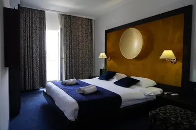 a hotel room with a large bed and a window at Apartments 29 in Inđija