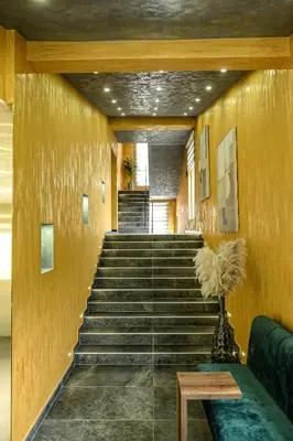 a staircase in a building with a green couch at Apartments 29 in Inđija