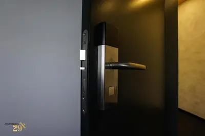 a black door with a metal handle on it at Apartments 29 in Inđija