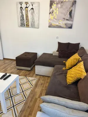 a living room with two beds and a couch at Lana apartman in Belgrade
