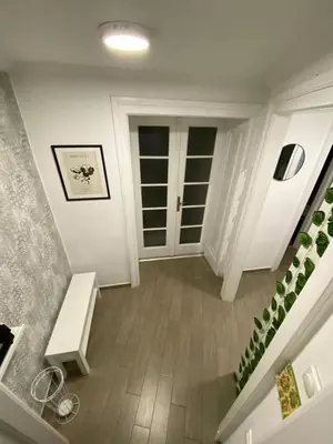 a hallway with a staircase and a white door at Lana apartman in Belgrade