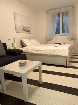 a living room with a bed and a coffee table at Lana apartman in Belgrade