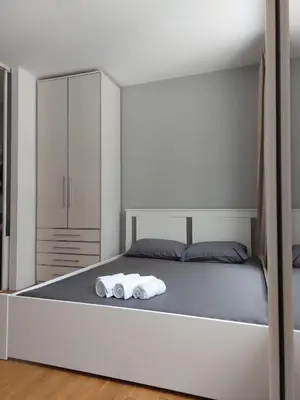 a bedroom with a bed with two towels on it at Apartman AMORE Belvil in Novi Beograd