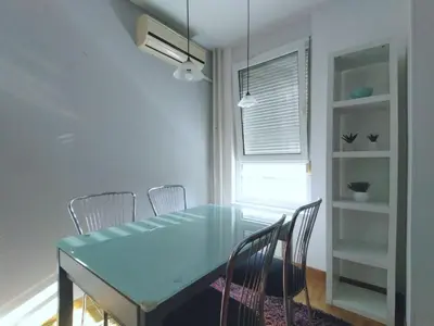 a dining room with a blue table and chairs at Apartman AMORE Belvil in Novi Beograd
