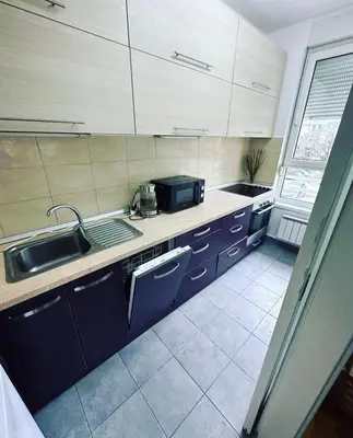 a kitchen with a sink and a counter top at Apartman AMORE Belvil in Novi Beograd