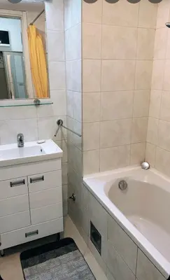 a bathroom with a white tub and a sink at Apartman AMORE Belvil in Novi Beograd