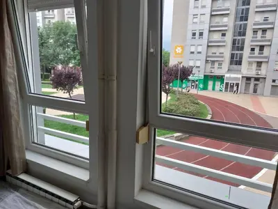 an open window with a view of a street at Apartman AMORE Belvil in Novi Beograd