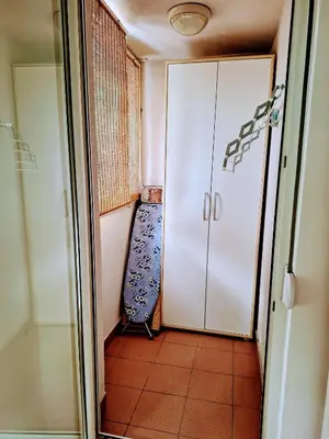 a corridor with a door and a chair in a room at Apartman AMORE Belvil in Novi Beograd