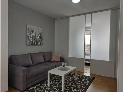 a living room with a couch and a table at Apartman AMORE Belvil in Novi Beograd