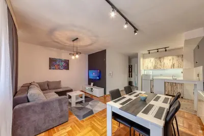 a living room with a couch and a table at Nobless in Belgrade