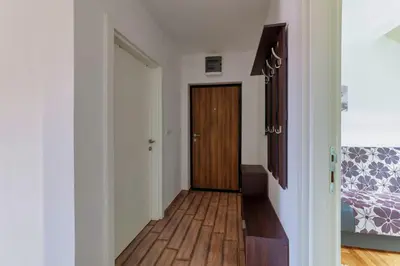 a hallway with a door leading to a bedroom at Nobless in Belgrade