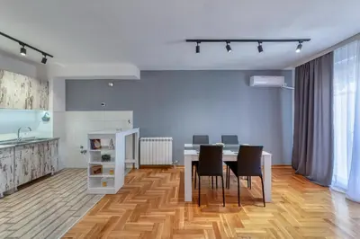 a kitchen and dining room with a table and chairs at Nobless in Belgrade