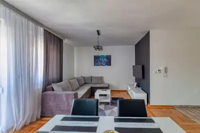 a living room with a couch and a table at Nobless in Belgrade