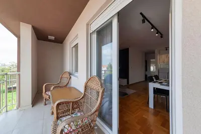 a balcony with a table and chairs and a desk at Nobless in Belgrade