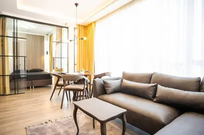 a living room with a couch and a table at Suite Music in Batajnica