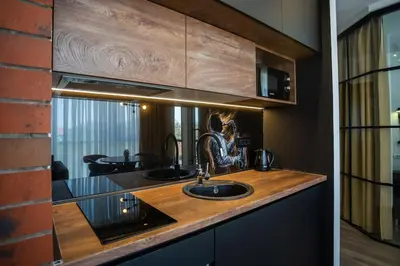 a kitchen counter with a sink and a mirror at Suite Music in Batajnica