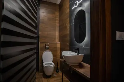 a bathroom with a toilet and a sink and a mirror at Suite Music in Batajnica