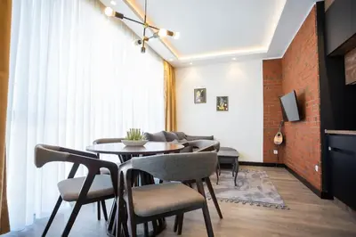 a dining room with a table and chairs at Suite Music in Batajnica