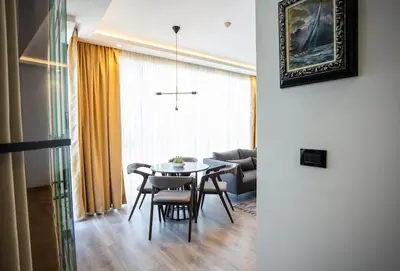 a dining room with a table and chairs at Suite Music in Batajnica