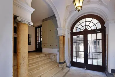 a large room with a staircase and a large window at APARTMAN KRUNA in Belgrade