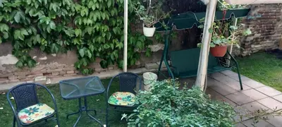 two chairs sitting in the grass in a garden at APARTMAN KRUNA in Belgrade