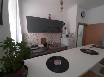 a kitchen with a white counter top and a table at TPC 9 in Žarkovo