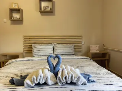 a bed with towels in the shape of hearts at Cozy Trg in Lazarevac