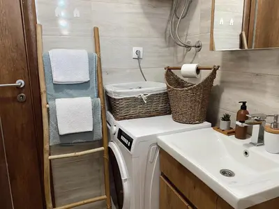 a bathroom with a washing machine and a sink at Cozy Trg in Lazarevac