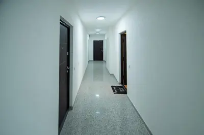 an empty corridor with white walls and a hallway at Hemingway LUX in Arandjelovac