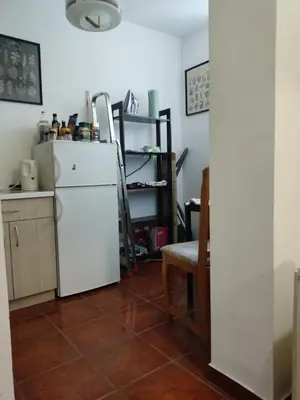 a kitchen with a white refrigerator and a table at Quiet city center oasis - In the shade of walnut in Belgrade