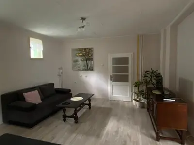 a living room with a couch and a table at Apartman Ema in Ruma