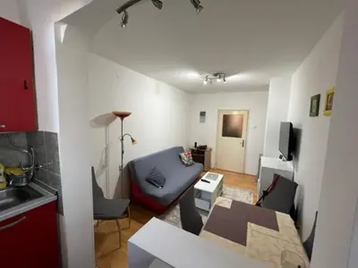 a small living room with a couch and a table at Sara in Zvezdara