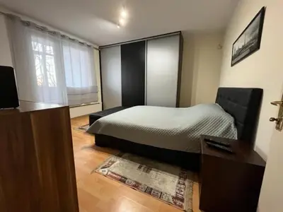 a bedroom with a bed and a desk and a television at Sara in Zvezdara