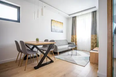 a living room with a dining room table and chairs at The boy next door apartment in Batajnica