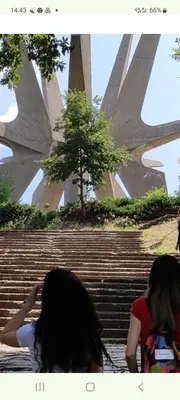 two girls sitting on the stairs in front of a building at Cvrkut Ptica - Mladenovac in Mladenovac