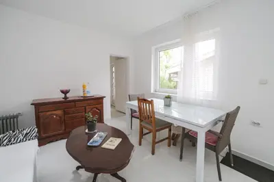 a living room with a table and chairs and a window at Cvrkut Ptica - Mladenovac in Mladenovac