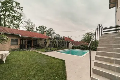 a swimming pool in a yard next to a house at Cvrkut Ptica - Mladenovac in Mladenovac