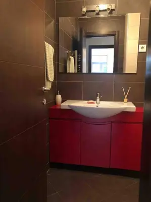 a bathroom with a white sink and a mirror at Azzaro apartment with two bedrooms in Bežanija