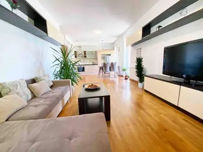 a living room with a couch and a flat screen tv at Azzaro apartment with two bedrooms in Bežanija