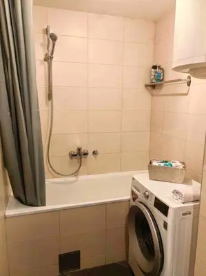 a bathroom with a shower and a washing machine at Azzaro apartment with two bedrooms in Bežanija