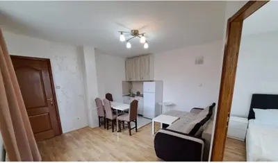 a small living room with a table and a kitchen at Apartmani MilaMi #3 in Kalugjerica
