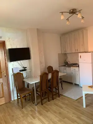 a kitchen and dining room with a table and chairs at Apartmani MilaMi #3 in Kalugjerica
