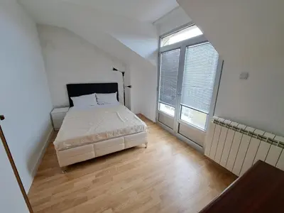 a bedroom with a bed and a large window at Apartmani MilaMi #3 in Kalugjerica