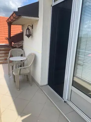 a patio with a table and chairs on a balcony at Apartmani MilaMi #3 in Kalugjerica