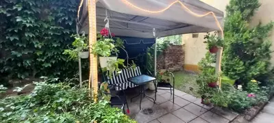 a pergola with a bench and some plants at APARTMAN KRUNA in Belgrade