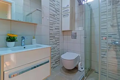 a bathroom with a toilet and a sink and a shower at APARTMAN KRUNA in Belgrade