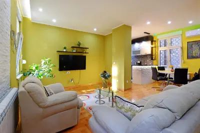 a living room with two couches and a tv at APARTMAN KRUNA in Belgrade